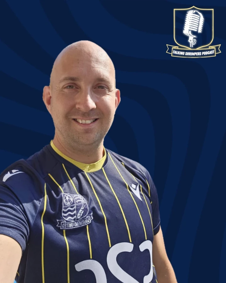 Charlie in a navy Southend shirt against a Talking Shrimpers backdrop.