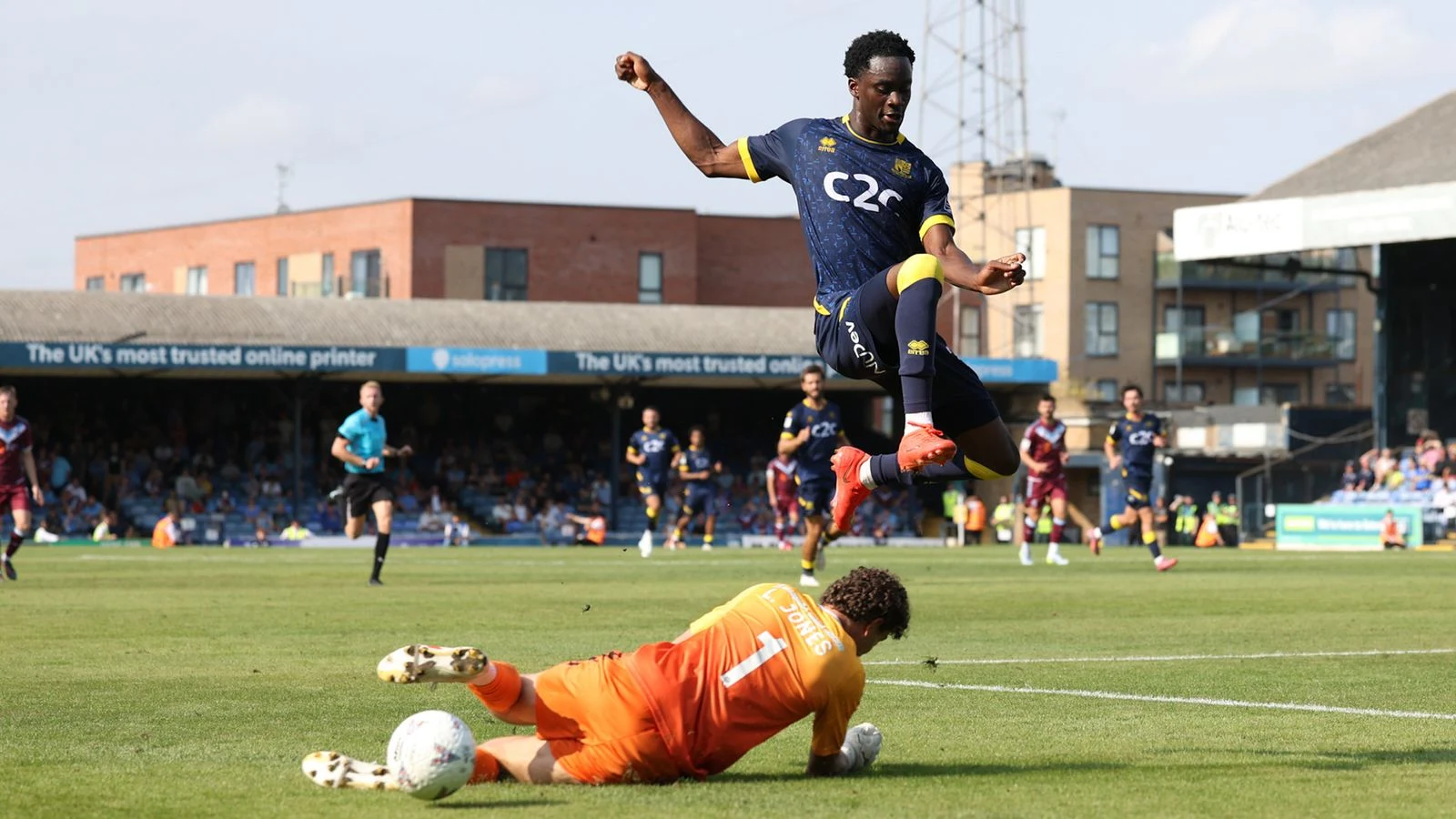 A Southend United player leaps over Scunthorpe goalkeeper Louis Jones during the 1-0 win at Roots Hall.