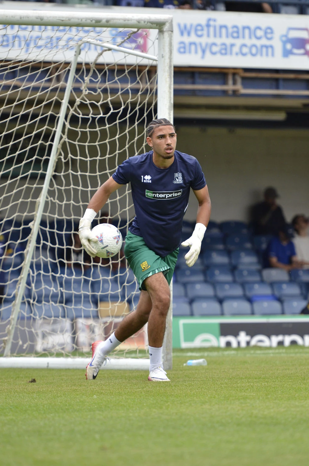 Southend goalkeeper carries the ball away from goal during the warm-up.