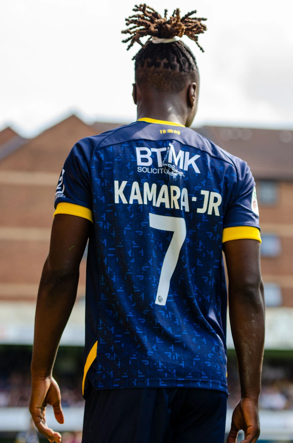Rear view of Southend's number seven standing on the pitch.